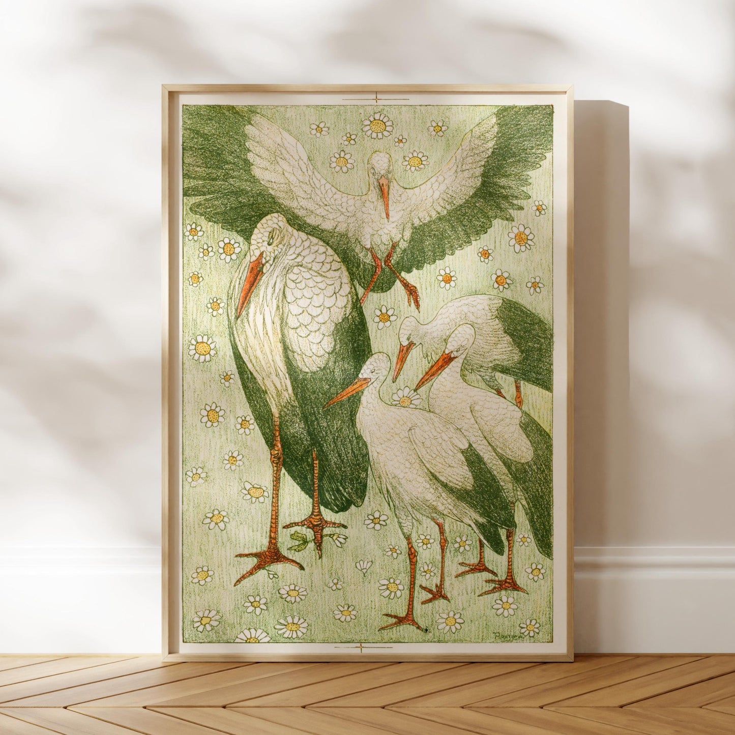 The image is a framed illustration of several storks, with a green background and white feathers. The storks are depicted in various poses, creating a dynamic and lively scene.